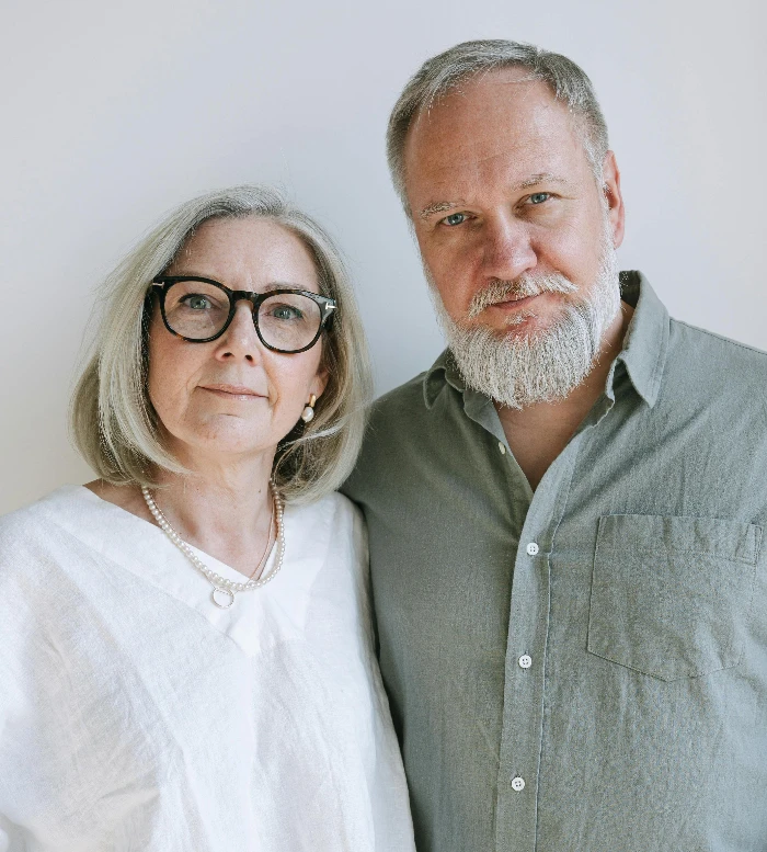 Charming portrait of elderly couple with eyeglasses and white hair, warm atmosphere.